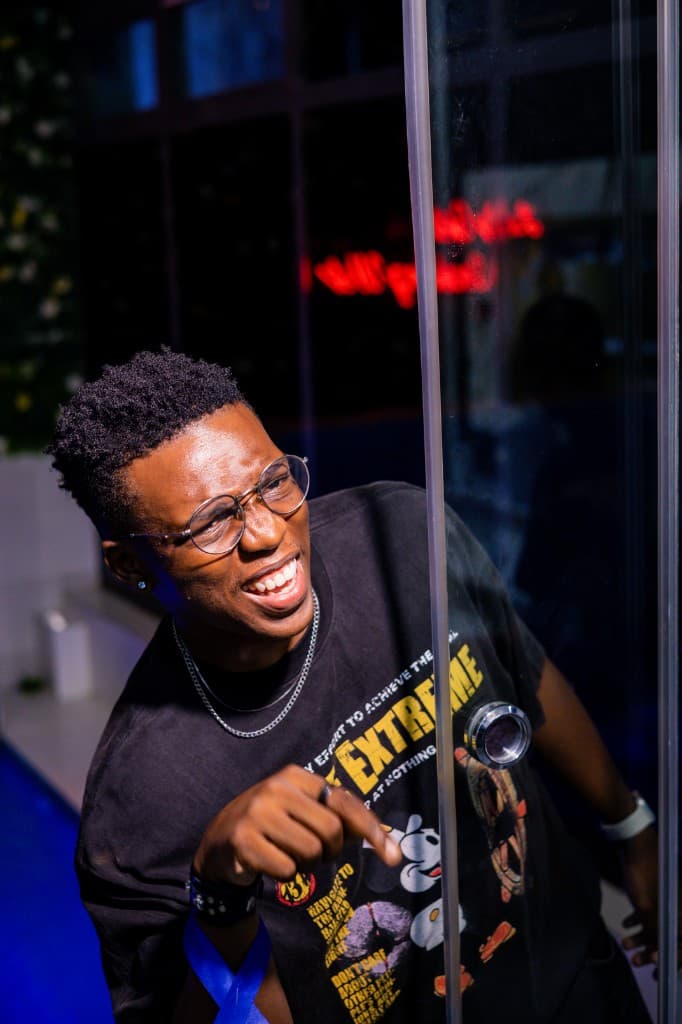 Guest pointing and laughing through a glass partition
